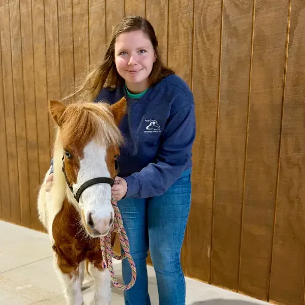Bailea Turnbow with a mini horse.